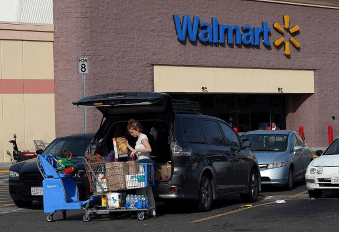 Walmart said Thursday overall sales have improved, led by food purchases. Still the number of customers visiting locations is down.