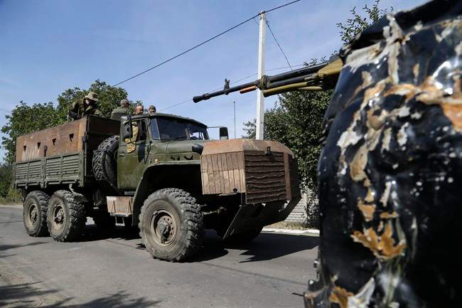 Pro-Russian rebels drive an armored truck in Donetsk, eastern Ukraine, Sunday, Sept. 7, 2014. 
