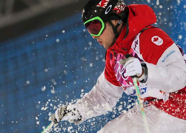 Canada's Alex Bilodeau makes his last run in the men's moguls final at the 2014 Winter Olympics, Monday, Feb. 10, 2014, in Krasnaya Polyana, Russia. Bilodeau won the gold medal. Bilodeau is retiring to take up accountancy.