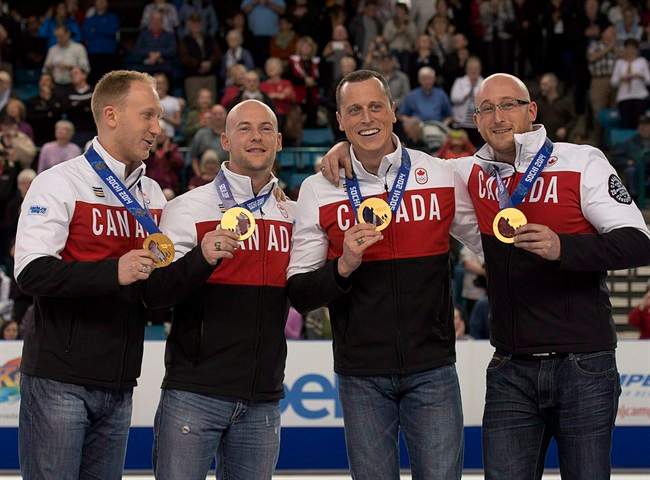 Olympic curling gold medallists Brad Jacobs, Ryan Fry, Ryan Harnden and E. J. Harnden, left to right, display their medals as they make an appearance at the Tim Hortons Brier in Kamloops, B.C. on Saturday, March 8, 2014. Never mind the new quadrennial. Team Brad Jacobs wants to be a force on the men's curling scene for at least the next eight years. THE CANADIAN PRESS/Andrew Vaughan.