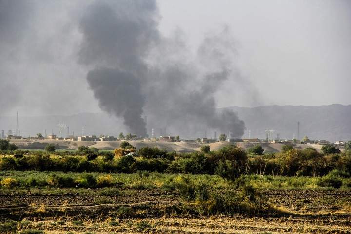 In this Thursday, July 31, 2014 photo, smoke rises from an oil refinery in Beiji, some 250 kilometers (155 miles) north of Baghdad, Iraq, after an attack by Islamic militants.