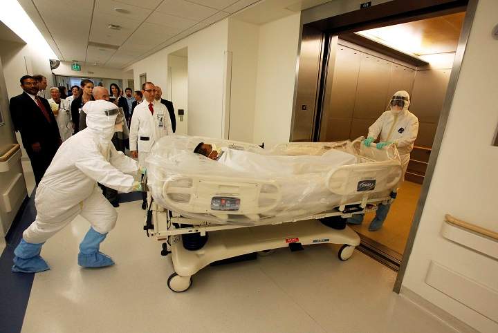 In this photo provided by the UCLA Health System, doctors and staff participate in a preparedness exercise on diagnosing and treating patients with Ebola virus symptoms, at the Ronald Reagan UCLA Medical Center in Los Angeles.