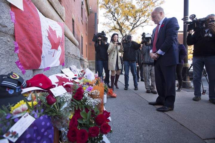 Bruce Heyman, the American Ambassador to Canada, pays his respects at a makeshift memorial to Nathan Cirillo that has been growing outside of The Lieutenant-Colonel John Weir Foote Armoury in Hamilton, Ontario.