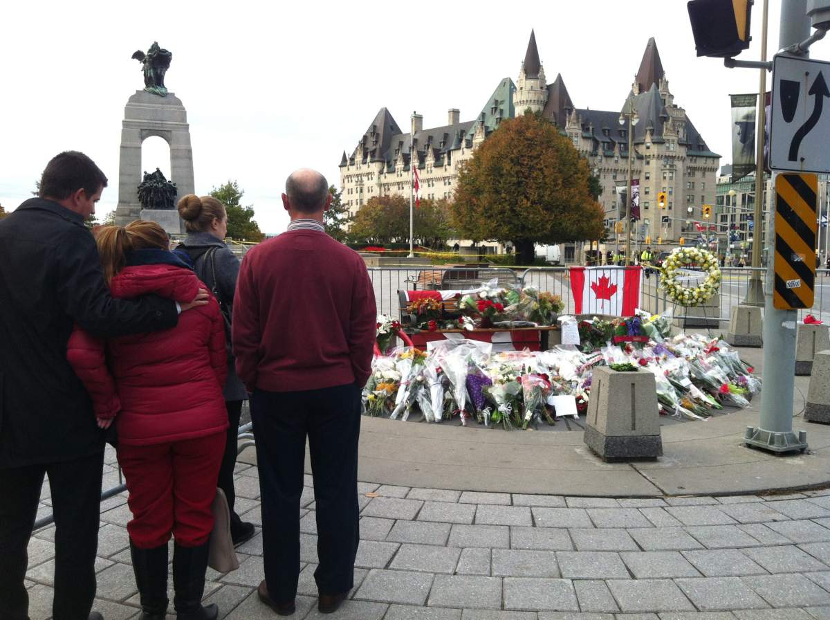Flowers and flags were placed in front of the National War Memorial on October 23, 2014, a day after Michael Zehaf-Bibeau shot Canadian soldier Corporal Nathan Cirillo in Ottawa, Ontario.