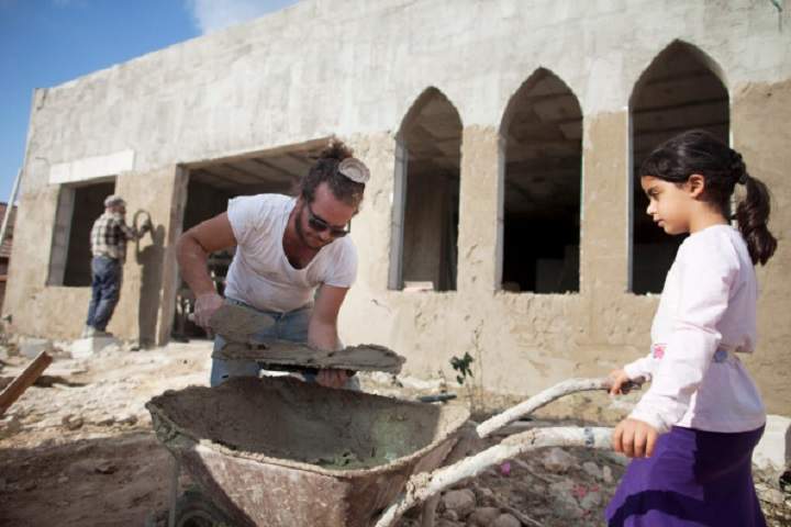 Jewish settlers work at a housing construction site on September 15, 2014 at the Jewish Settlement  of Bat Ayin , West Bank. Israel's Civil Administration in the West Bank last week announced the takeover of 988 acres (3,799 dunams) belonging to five Palestinian villages between the Etzion settlement bloc and Jerusalem. 