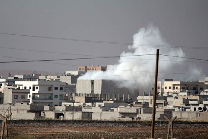 A photograph taken from Suruc district of Sanliurfa, southeastern province of Turkey, shows smoke rises during the clashes between the Islamic State of Iraq and Levant (ISIL) and Kurdish armed troops in Kobane (Ayn al-arab) city of Syria, on October 10, 2014. 