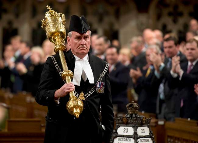Sergeant-at-Arms Kevin Vickers receives a standing ovation as he enters the House of Commons Thursday October 23, 2014 in Ottawa.