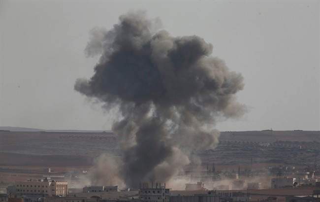 Smoke rises following an airstrike by US-led coalition aircraft in Kobani, Syria, during fighting between Syrian Kurds and the militants of Islamic State group, Thursday, Oct. 9, 2014. 