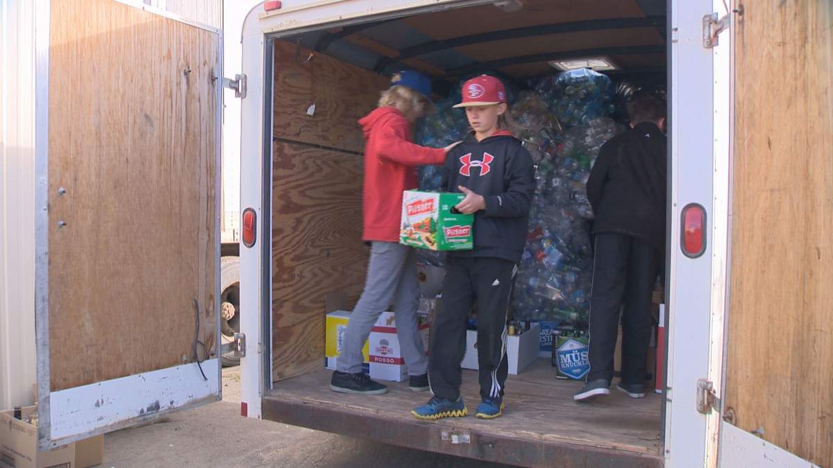 Mason Engele (left), Thomas Puetz (middle), and Luke Hanson (right) moved their collection of recyclables to a SARCAN location (6175 Rochdale Blvd.) in this file photo. 