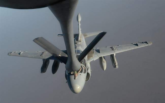 In this Saturday, Oct. 4, 2014 photo, released by the U.S. Air Force, A U.S. Navy EA-6B Prowler supporting operations against the militant Islamic State group, receives fuel from a KC-135 Stratotanker over Iraq.