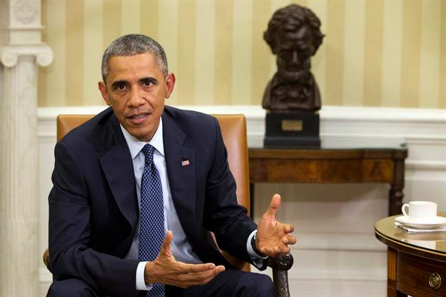 President Barack Obama speaks to the media about the government’s Ebola response, in the Oval Office of the White House Thursday, Oct. 16, 2014, in Washington.