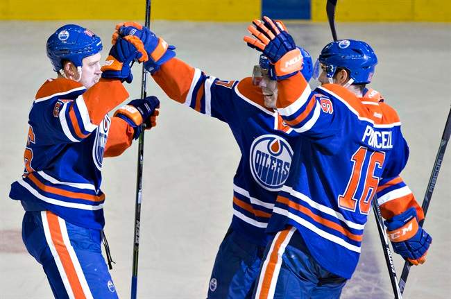 dmonton Oilers' Nikita Nikitin (86), David Perron (57) and Teddy Purcell (16) celebrate a goal against the Washington Capitals during second period NHL hockey action in Edmonton, Alta., on Wednesday October 22, 2014.