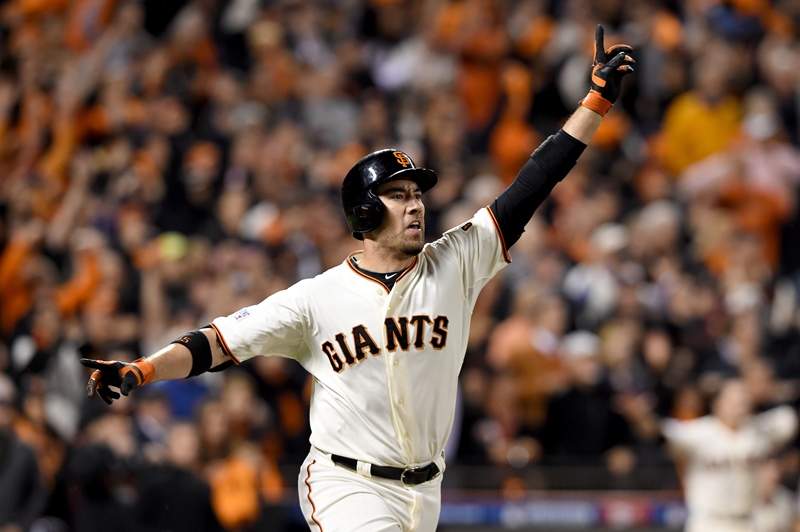 Travis Ishikawa #45 of the San Francisco Giants celebrates after he hits a three-run walk-off home run to defeat the St. Louis Cardinals 6-3 during Game Five of the National League Championship Series at AT&T Park on October 16, 2014 in San Francisco, California. 