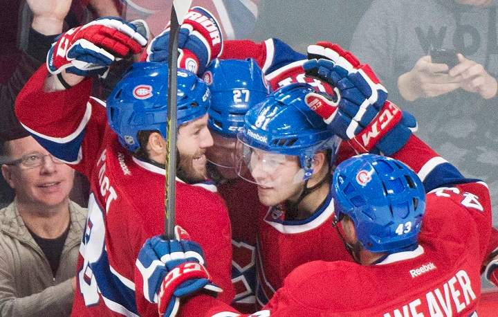 Montreal Canadiens' Alex Galchenyuk (27) celebrates with teammates Brandon Prust (8), Lars Eller (81) and Mike Weaver (43) after scoring against the Colorado Avalanche during second period NHL hockey action in Montreal, Saturday, October 18, 2014.