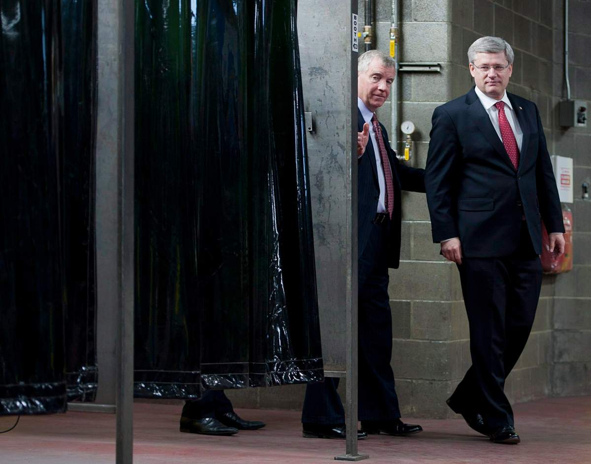 Canadian Prime Minister Stephen Harper, right, and MP Laurie Hawn. THE CANADIAN PRESS/John Ulan.