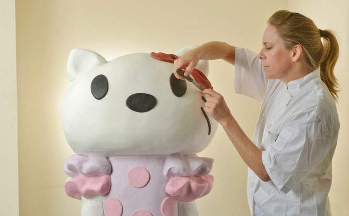 Cake artist Sarah Hardy is pictured creating a life size Hello Kitty cake for the character’s 40th anniversary in London on October 31, 2014.
