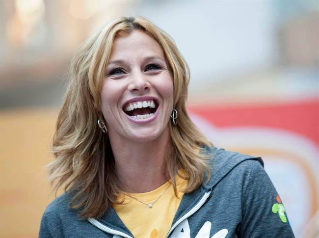 Former Olympian Catriona Le May Doan laughs during the announcement of the route for the Toronto 2015 Pan Am Torch Relay at the Eaton Centre in Toronto on Wednesday, Oct. 1, 2014.