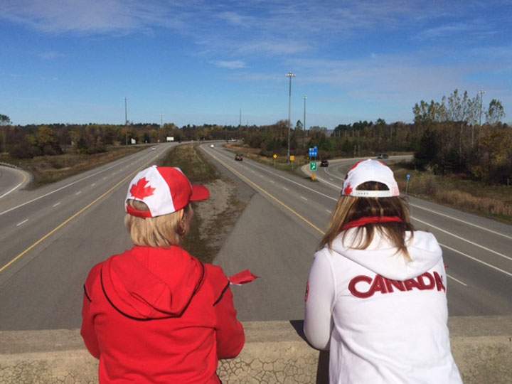 People gather on an overpass along Hwy. 401 on Friday, October 24, 2014.