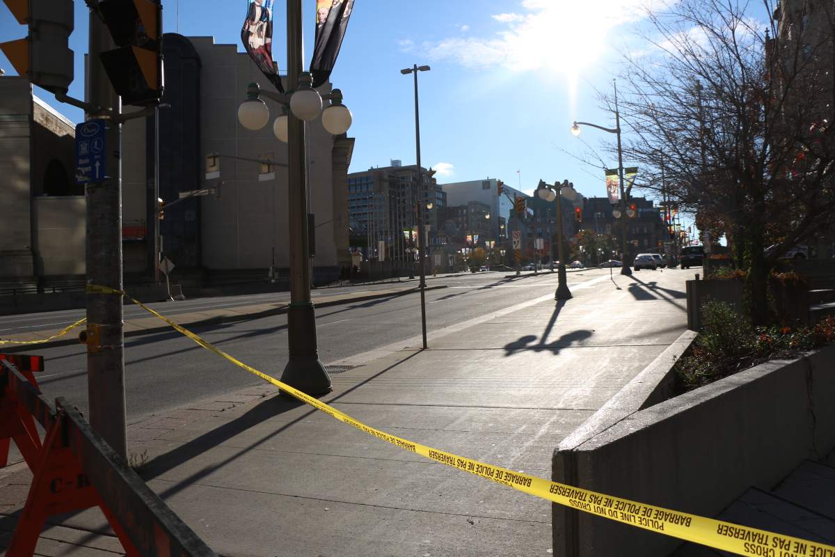 Ottawa's Wellington Street remained behind a police cordon late Wednesday afternoon after a fatal shooting at the War Memorial.