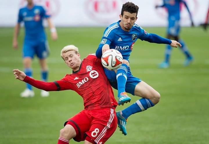 Toronto FC's Kyle Bekker, left, and Montreal Impact's Felipe Martins battle for the ball during the second half of MLS soccer action in Toronto on Saturday, October 18, 2014.