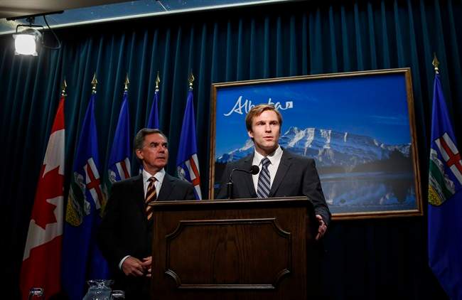Alberta Premier Jim Prentice, left, and New Brunswick Premier Brian Gallant hold a joint news conference in Calgary on Oct. 20, 2014.