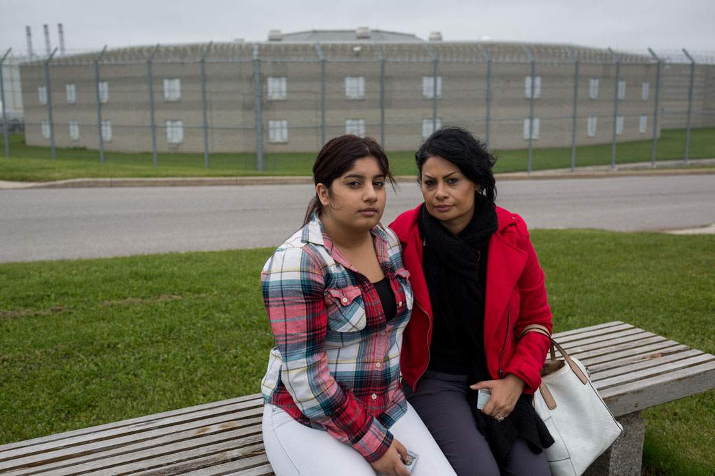 Pam Shiraldini and Melika Mojarrab, 15, sit in front of the Lindsay jail after visting Masoud Hajivand, held in immigration detention there.