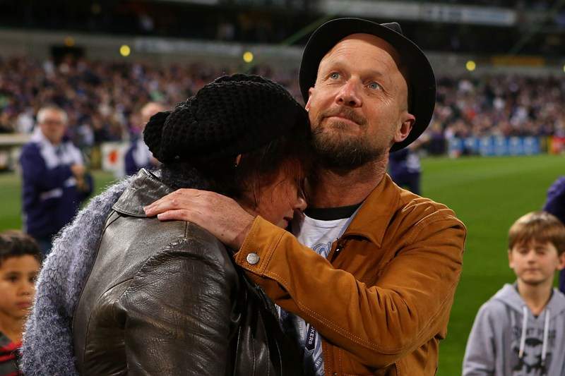 Parents of MH17 crash victims Evie, Mo and Otis Maslin, Marite Norris is comforted by Anthony Maslin after releasing balloons before an AFL match on July 31, 2014 in Perth, Australia. 
