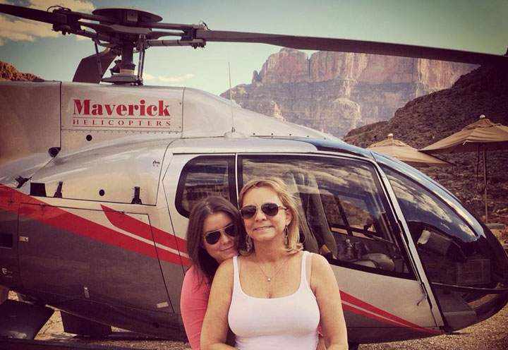 In this Oct. 21, 2014 photo provided by TheBrittanyFund.org, Brittany Maynard, left, hugs her mother Debbie Ziegler next to a helicopter at the Grand Canyon National Park in Arizona.