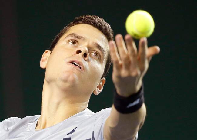 Milos Raonic serves the ball to Jack Sock during their first round match at the ATP World Tour Masters tennis tournament at Bercy stadium in Paris, France, Wednesday, Oct. 29, 2014. 