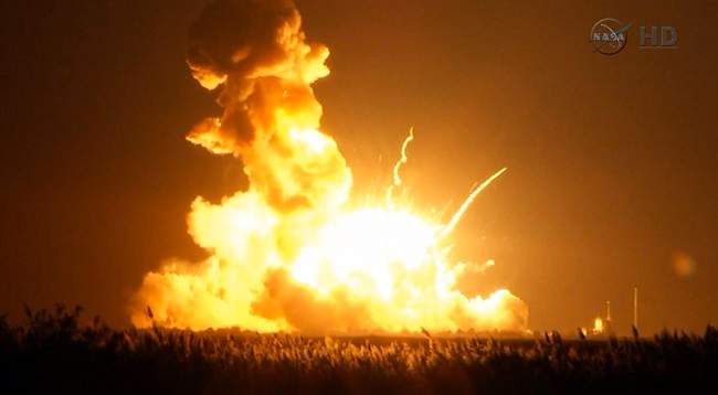 This image taken from video provided by NASA TV shows Orbital Sciences Corp.’s unmanned rocket blowing up over the launch complex at Wallops Island, Va., just six seconds after liftoff.