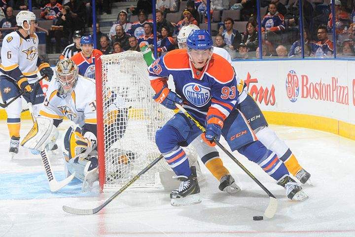 Ryan Nugent-Hopkins #93 of the Edmonton Oilers battles for position in a game against the Nashville Predators on October 29, 2014 at Rexall Place in Edmonton, Alberta.
