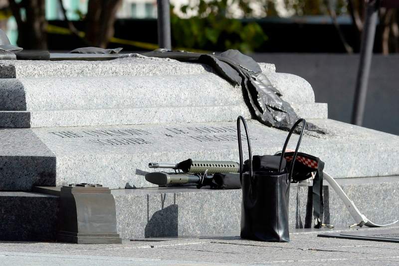 Weapons and personal belongings are pictured at the National War Memorial as police secure the area near Parliament Hill in Ottawa on Wednesday Oct.22, 2014. 