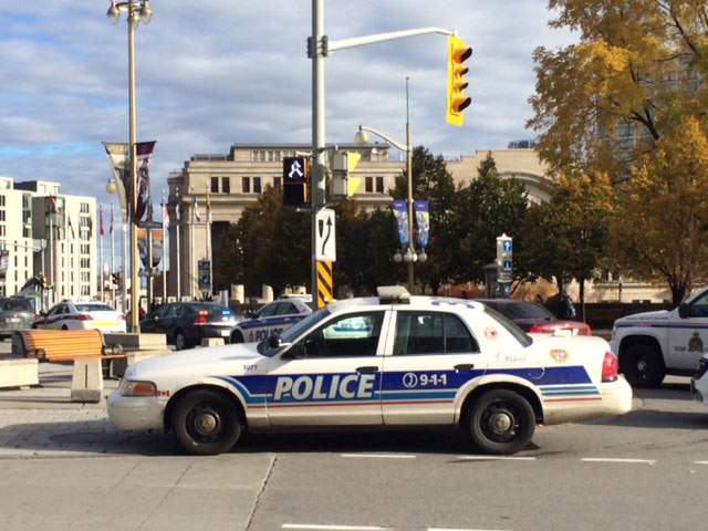 Police respond after a soldier was shot and killed near the War Memorial in Ottawa.