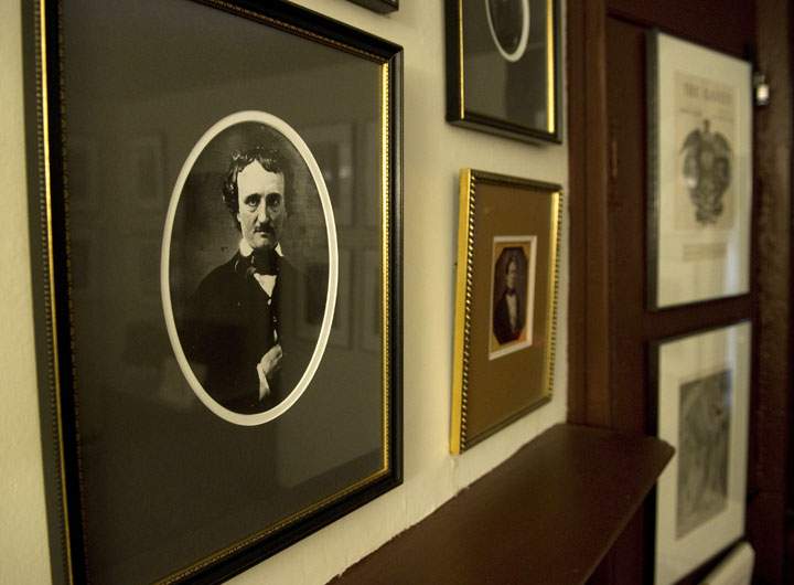 Photos of US writer Edgar Allan Poe and his family, hang on the wall of the Edgar Allan Poe House and Museum, located in the writer's former home in Baltimore, Maryland, on August 11, 2011.