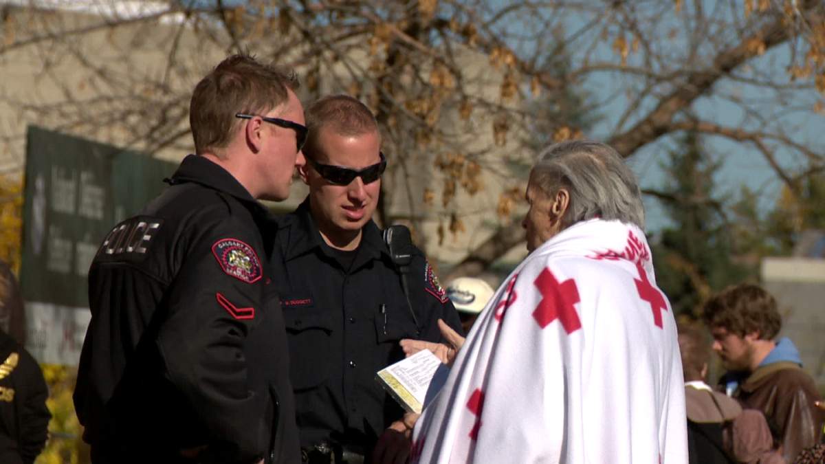 Displaced residents lined up outside Mewata Armouries Tuesday. 