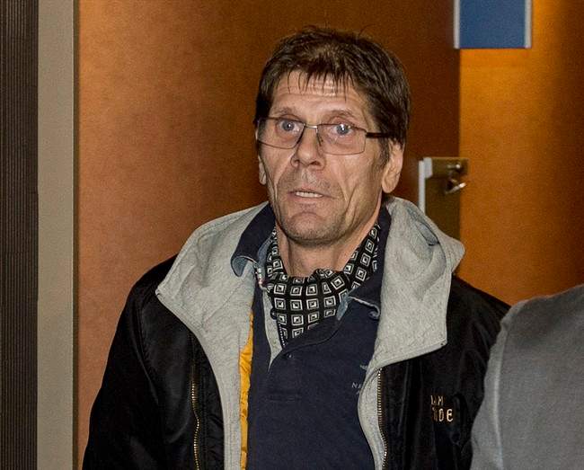 Witness Frank Rubert, from Berlin, leaves the courtroom after testifying at the murder trial for Luka Magnotta Wednesday, Oct. 8, 2014 in Montreal.