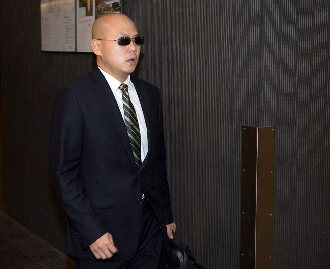 Dong Dong Xu, a friend of victim Jun Lin, arrives to testify at the murder trial for Luka Magnotta Tuesday, Oct. 7, 2014 in Montreal.