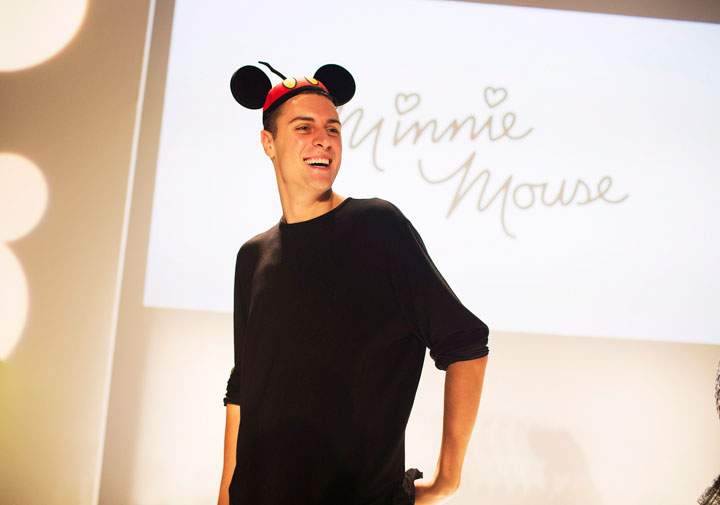 Finalist Sid Neigum is crowned with mouse ears after winning the Mercedez-Benz Start Up program where finalists created designs inspired by Minnie Mouse at World MasterCard Fashion Week in Toronto on Tuesday, October 21, 2014. 