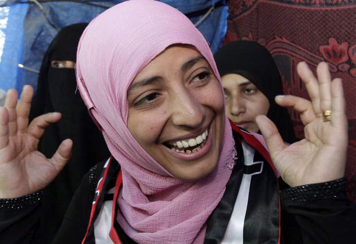 FILE – In this Saturday, Oct. 8, 2011 file photo, Yemeni activist Tawakkul Karman, one of three recipients of the 2011 Nobel Peace Prize, receives congratulations from protestors at her tent in Change Square in Sanaa, Yemen.
