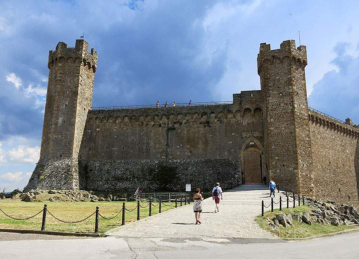 This June 10, 2014 photo shows the medieval fortress in the town of Montalcino in Tuscany, Italy. Walking tours of Tuscany offer many scenic, historic spots like this one.