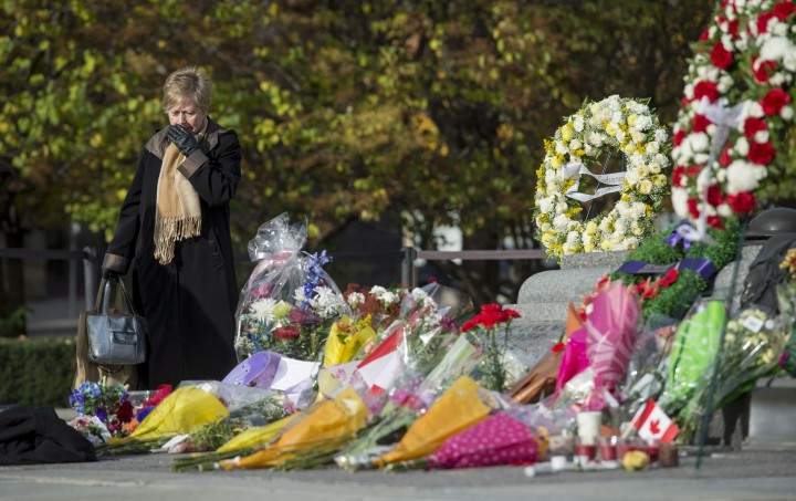 A woman leaves the Tomb of the Unknown Soldier after paying her respects at the National War Memorial, where Cpl. Nathan Cirillo, 24, was killed by a gunman, in Ottawa on Friday, Oct. 24, 2014. THE CANADIAN PRESS/Justin Tang