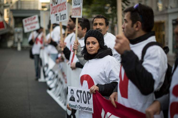 TORONTO, ON: Pan Shiraldini at the rally in Toronto’s Dundas Square to protest her husband Masoud Hajivani’s impending deportation. About 20 members of the community held signs and stood silently in the square at 5PM, occasionally answering questions from curios bystanders.