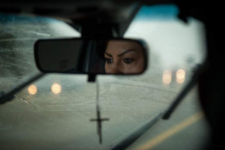 Pam Shiraldini’s face is reflected in the rear-view mirror near Lindsay as she drives to the Lindsay jail.