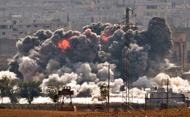 Smoke and flames rise from an Islamic State fighters' position in the town of Kobani during airstrikes by the US led coalition seen from the outskirts of Suruc, near the Turkey-Syria border, Tuesday, Oct. 28, 2014. 