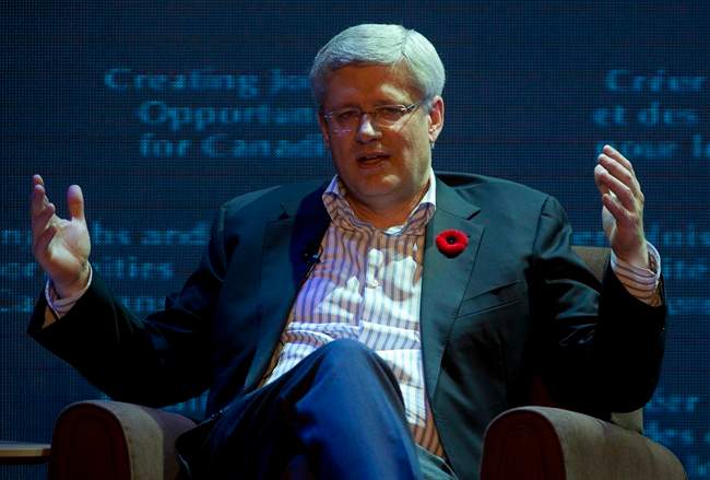 Canadian Prime Minister Stephen Harper responds during a question and answer session with Executive Chairman of Alibaba Group Jack Main in Hangzhou, China Friday November 7, 2014. 