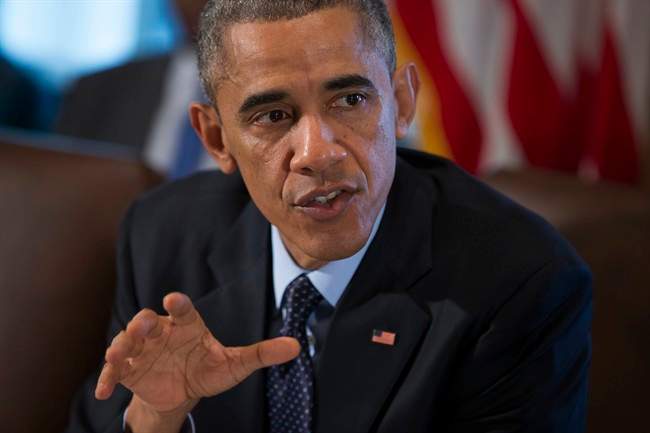 President Barack Obama speaks to the media before a meeting with his cabinet members in the White House Cabinet Room in Washington, Friday, Nov. 7, 2014.