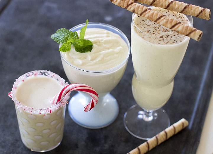 This Nov. 10, 2014 photo shows, from left to right, white chocolate peppermint eggnog, light and airy eggnog and classic eggnog in Concord, N.H. A great eggnog requires few ingredients, but it's safer to cook the eggs, which also ensures the eggnog develops a thick, rich texture.