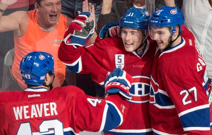 Montreal Canadiens' Brendan Gallagher (11) celebrates with teammates Alex Galchenyuk (27) and Mike Weaver after scoring against the Minnesota Wild during second period NHL hockey action in Montreal, Saturday, November 8, 2014.