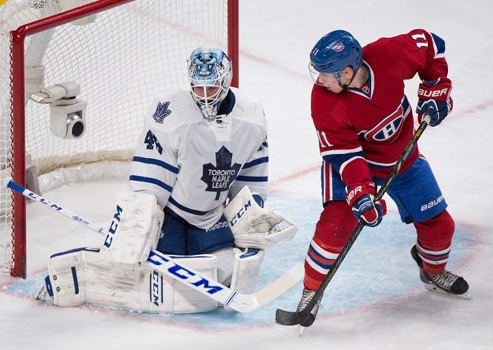 Montreal Canadiens' Brendan Gallagher, right, moves in on Toronto Maple Leafs' goaltender Jonathan Bernier.
