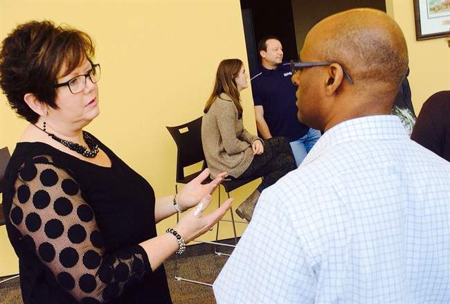Joan Jessome, president of the Nova Scotia Government and General Employees Union, talking to an unidentified union member in Halifax on Nov.18, 2014. 